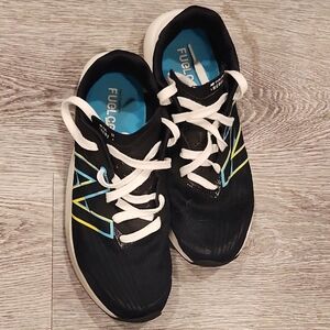 New Balance Black Athletic Shoes with Blue and Yellow Accents